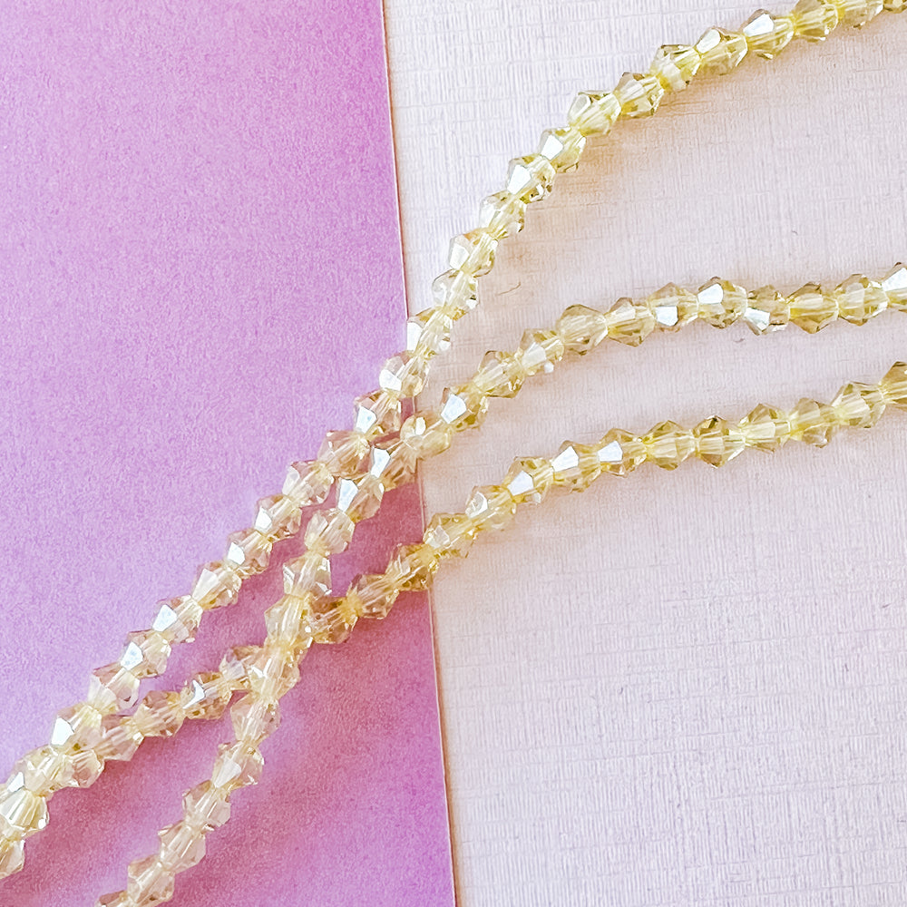 3mm Golden Clear Faceted Crystal Bicone Strand