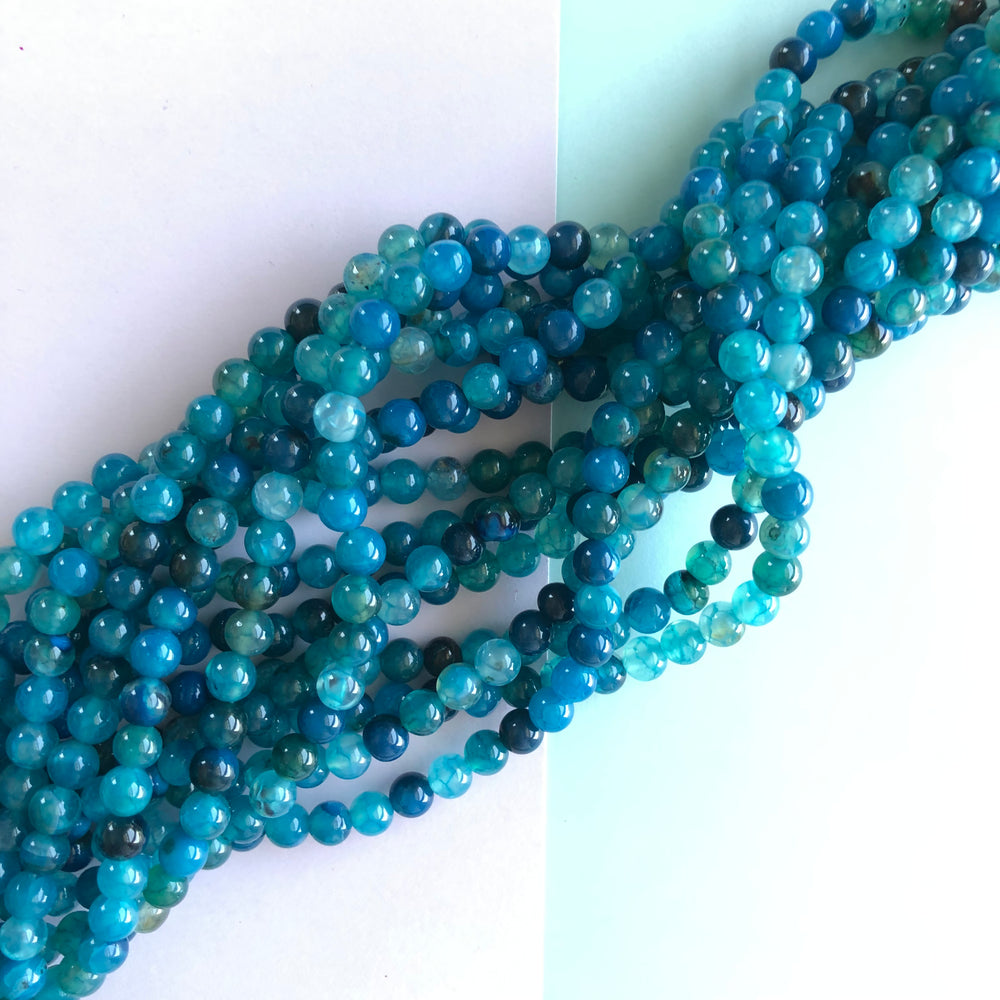 
                
                    Load image into Gallery viewer, 6mm Blue Raspberry Smooth Agate Round Strand
                
            