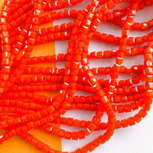 
                
                    Load image into Gallery viewer, 4mm Bright Orange Faceted Cube Crystal Strand
                
            