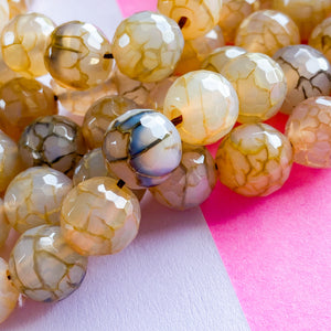 
                
                    Load image into Gallery viewer, 12mm Faceted Tan Luxe Agate Rounds Strand
                
            