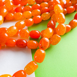 
                
                    Load image into Gallery viewer, 12mm Bright Orange Dyed Agate Barrel Strand
                
            