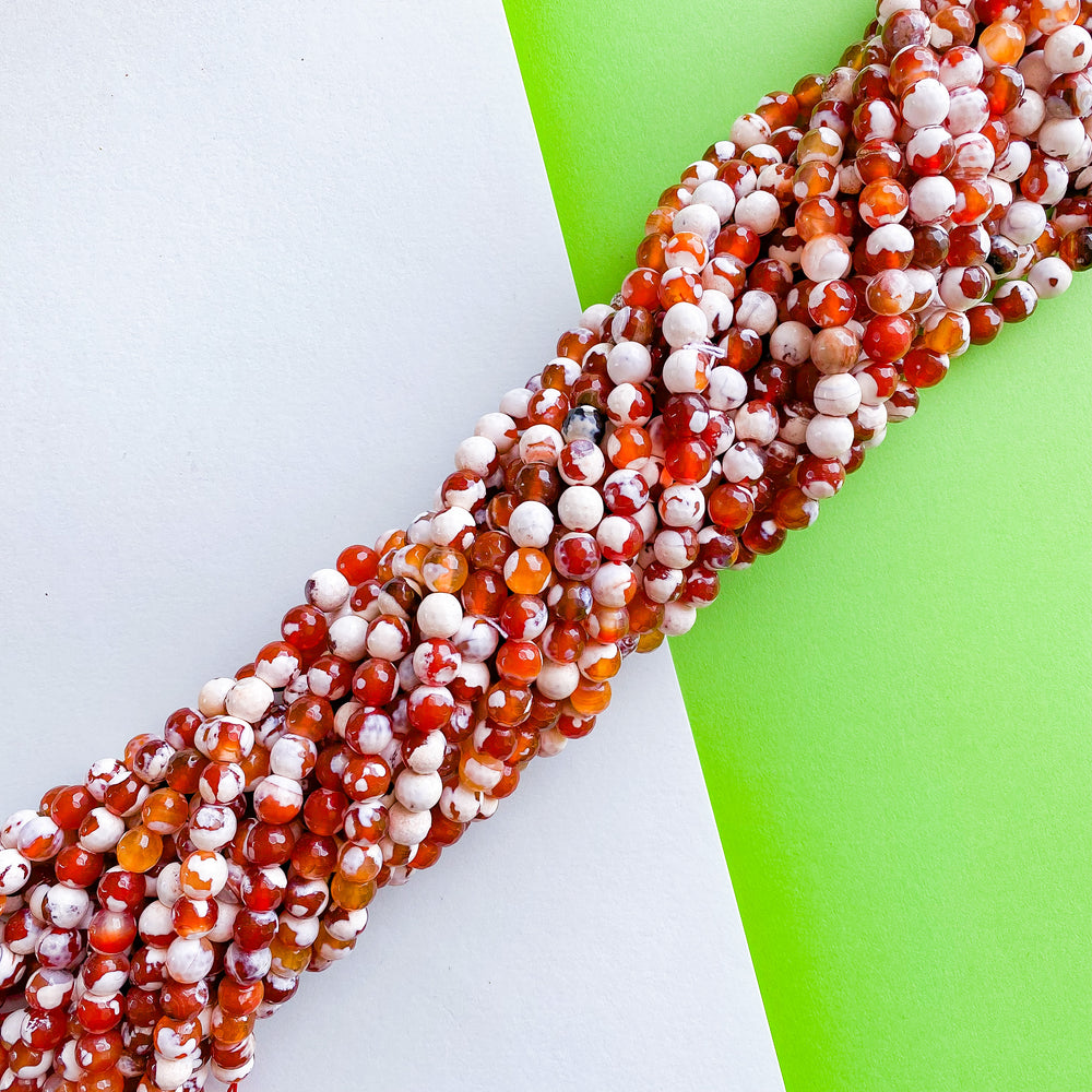 
                
                    Load image into Gallery viewer, 8mm Faceted Red and White Spotted Carnelian Rounds Strand
                
            