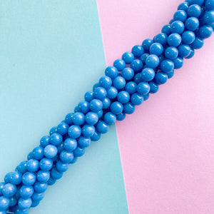 
                
                    Load image into Gallery viewer, 8mm Smooth Blue Dyed Calcite Rounds Strand
                
            