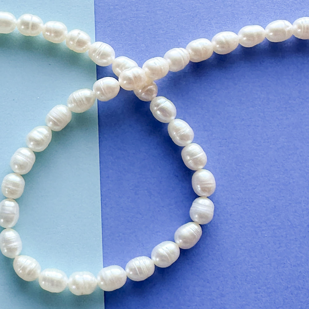 
                
                    Load image into Gallery viewer, 6mm White Freshwater Oval Pearl Strand
                
            