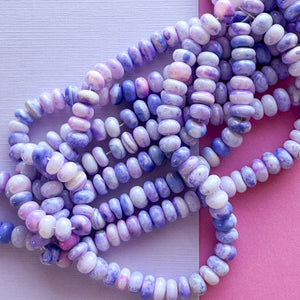 
                
                    Load image into Gallery viewer, 7mm Smooth Varigated Violet Dyed Opal Rondelle Strand
                
            