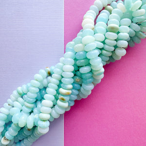 
                
                    Load image into Gallery viewer, 9mm Smooth Light Blue Dyed Opal Rondelle Strand
                
            