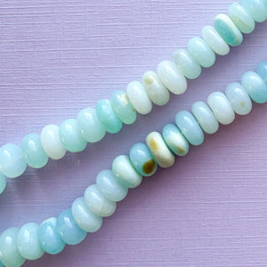 
                
                    Load image into Gallery viewer, 9mm Smooth Light Blue Dyed Opal Rondelle Strand
                
            