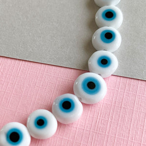 
                
                    Load image into Gallery viewer, 6mm White and Blue Evil Eye Glass Coin Strand
                
            