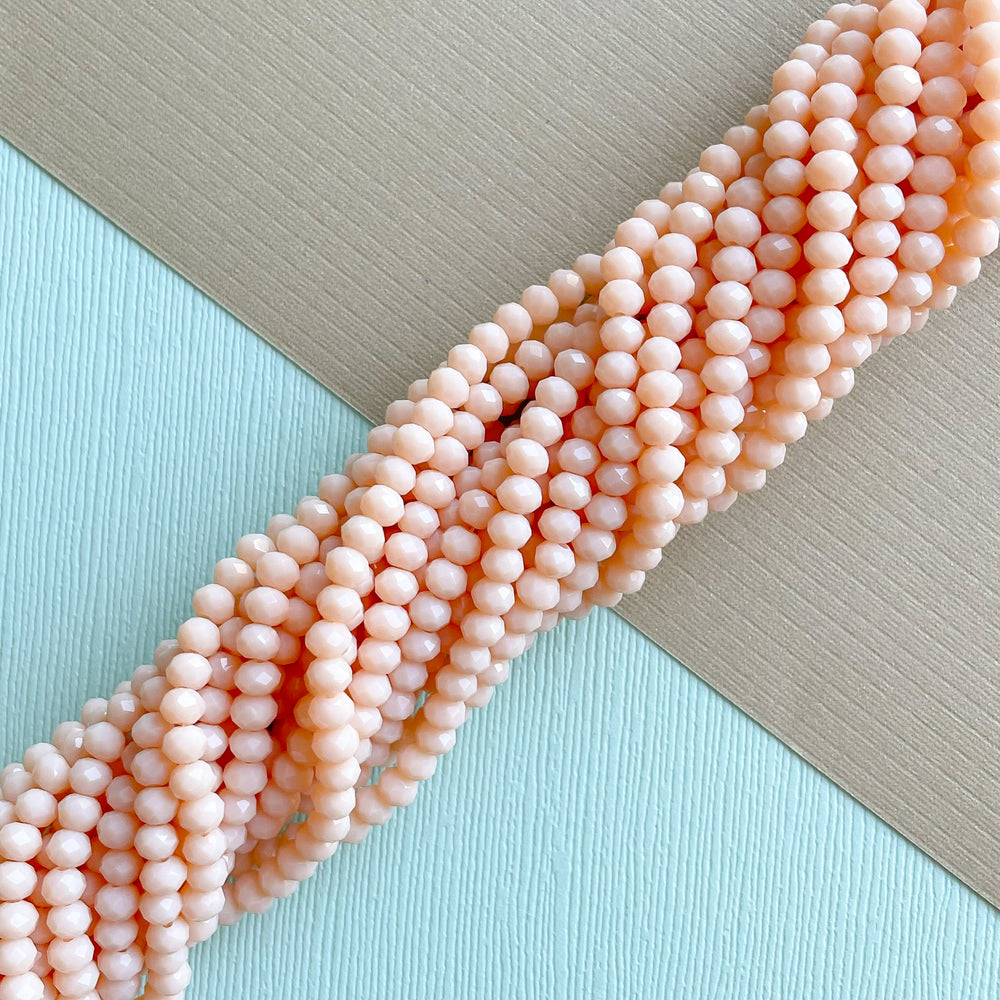 
                
                    Load image into Gallery viewer, 4mm Pale Apricot Faceted Chinese Crystal Rondelle Strand
                
            