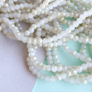 
                
                    Load image into Gallery viewer, 4mm Matte Arctic White Two-Tone Faceted Chinese Crystal Rondelle Strand
                
            