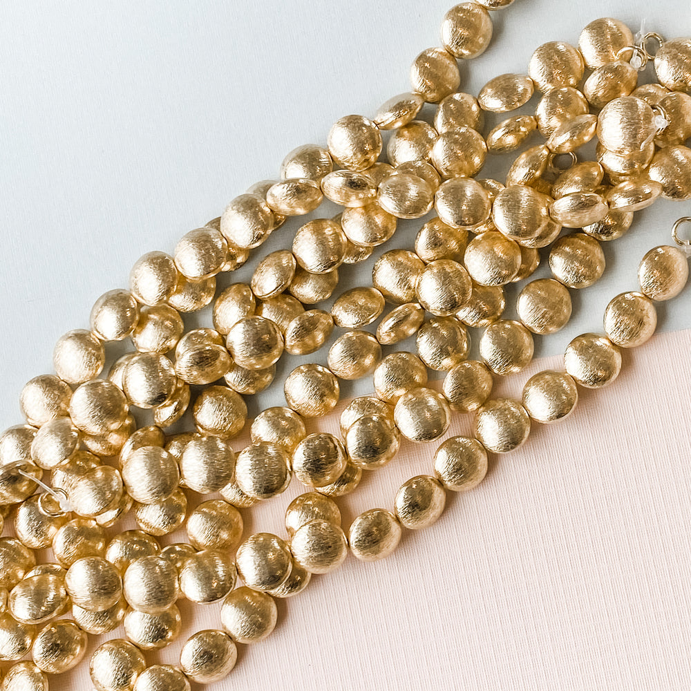 
                
                    Load image into Gallery viewer, 12mm Gold Brushed Puffed Coin Strand
                
            