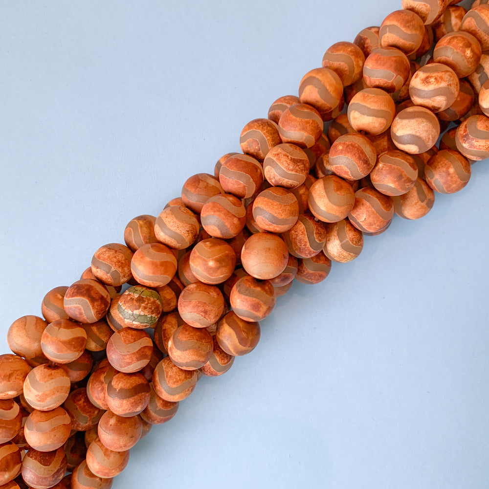 
                
                    Load image into Gallery viewer, 10mm Smooth Matte Rust DZI Agate Round Strand
                
            