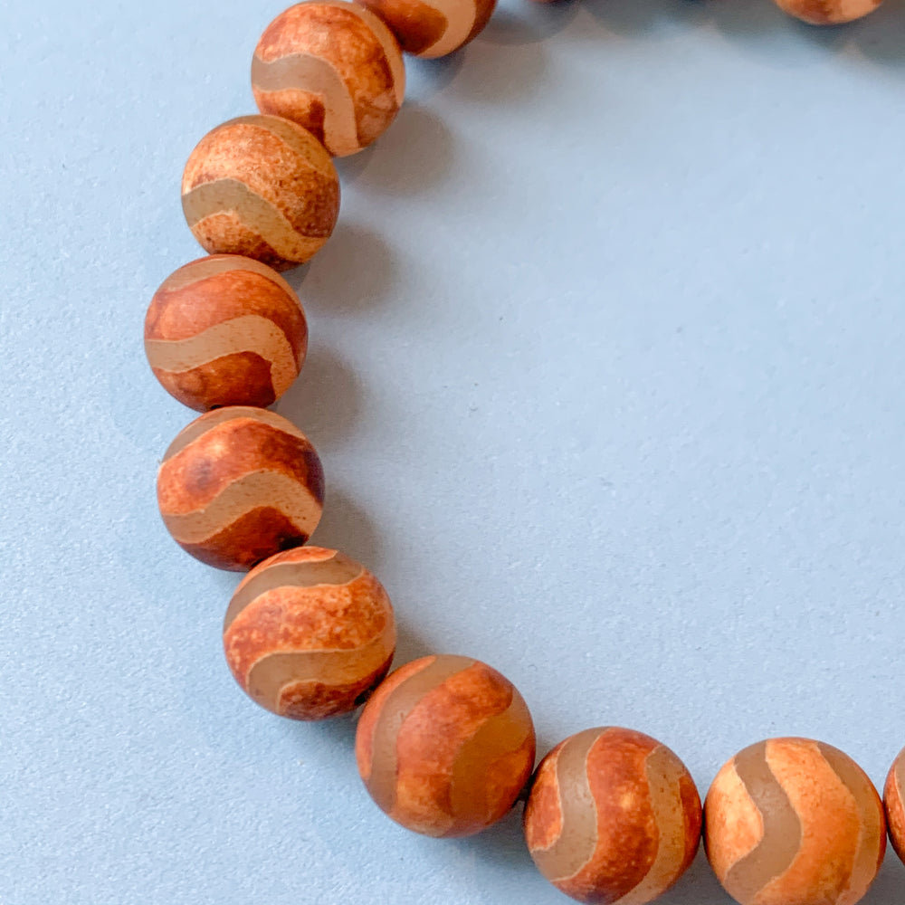 
                
                    Load image into Gallery viewer, 10mm Smooth Matte Rust DZI Agate Round Strand
                
            