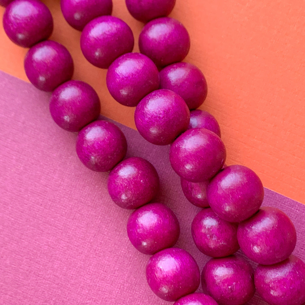 
                
                    Load image into Gallery viewer, 12mm Plum Wood Rounds Strand
                
            