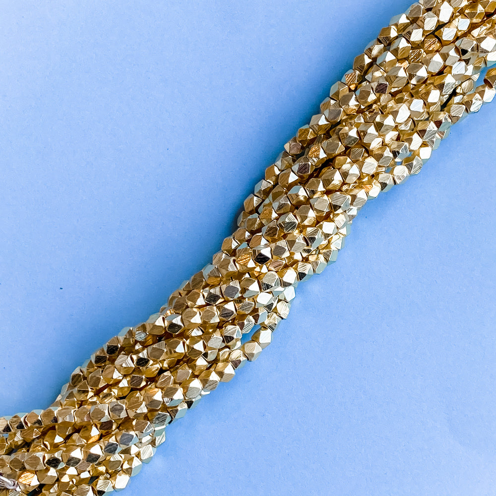 
                
                    Load image into Gallery viewer, 4mm Gold Faceted Nugget Strand
                
            