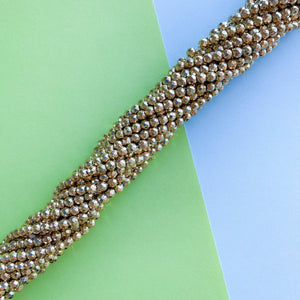 
                
                    Load image into Gallery viewer, 4mm Gold Faceted Hematite Rounds Strand
                
            