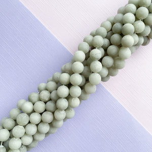 
                
                    Load image into Gallery viewer, 8mm Matte Ecru Dyed Jade Rounds Strand
                
            