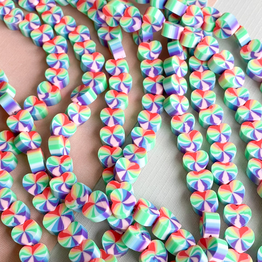 
                
                    Load image into Gallery viewer, 10mm Rainbow Heart Polymer Clay Strand
                
            