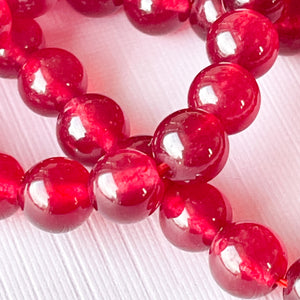 
                
                    Load image into Gallery viewer, 8mm Smooth Crimson Dyed Jade Rounds Strand
                
            
