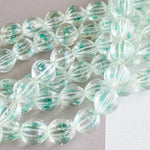 10mm Teal Fleck Fluted Glass Rounds Strand
