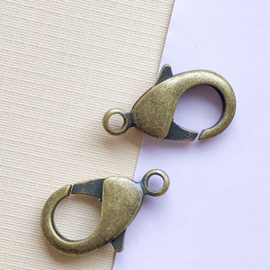 
                
                    Load image into Gallery viewer, 27mm Antique Brass Lobster Claw Clasp - 2 Pack
                
            