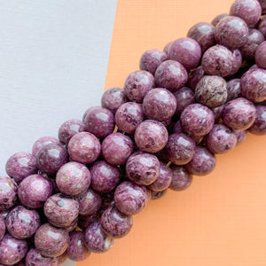 
                
                    Load image into Gallery viewer, 8mm Mauve Spotted Smooth Dyed Jade Strand
                
            