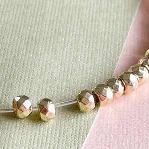 
                
                    Load image into Gallery viewer, 3mm Gold Faceted Hematite Rondelle Strand
                
            