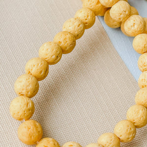 
                
                    Load image into Gallery viewer, 6mm Mustard Yellow Lava Rounds Strand
                
            