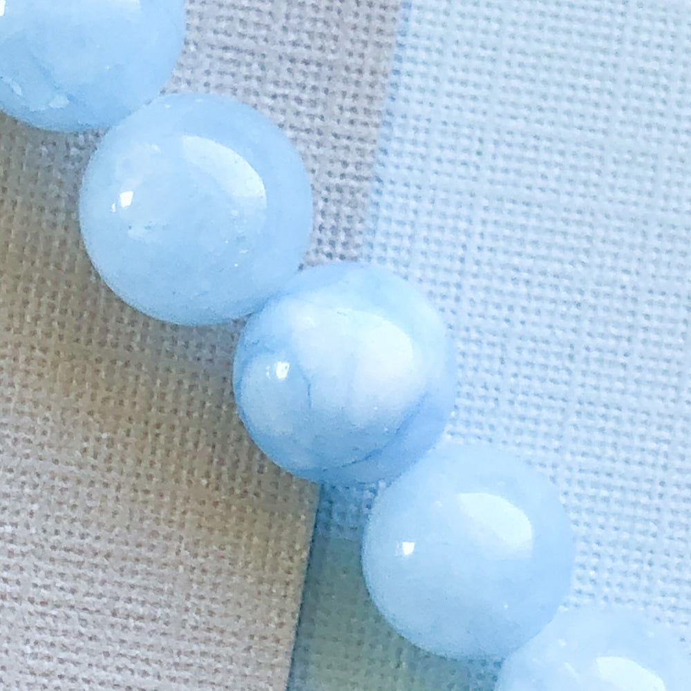 
                
                    Load image into Gallery viewer, 8mm Icy Blue Dyed Jade Rounds Strand
                
            
