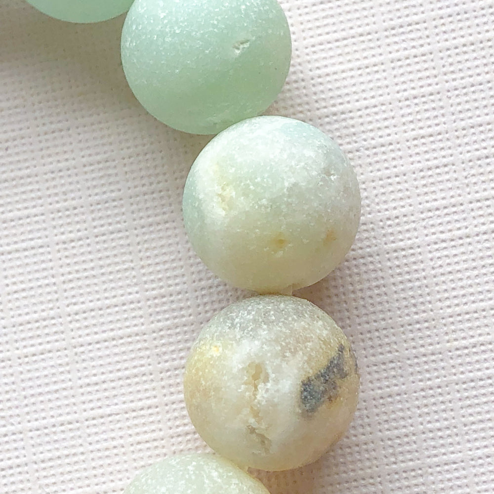 
                
                    Load image into Gallery viewer, 10mm Matte Amazonite Rounds Strand - Christine White Style
                
            