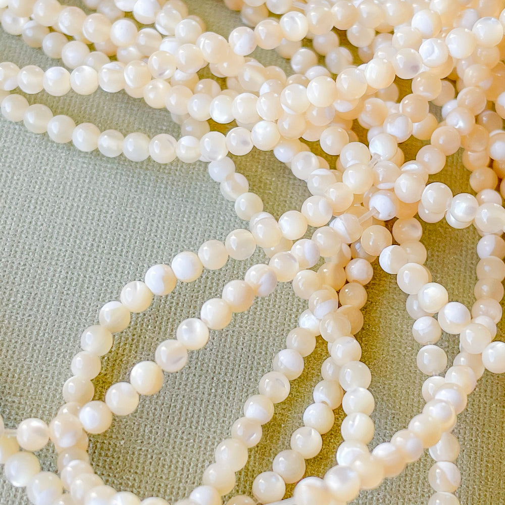 
                
                    Load image into Gallery viewer, 2mm Smooth Mother of Pearl Rounds Strand
                
            