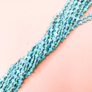 
                
                    Load image into Gallery viewer, 10mm Turquoise Dyed Magnesite Cross Strand - Christine White Style
                
            