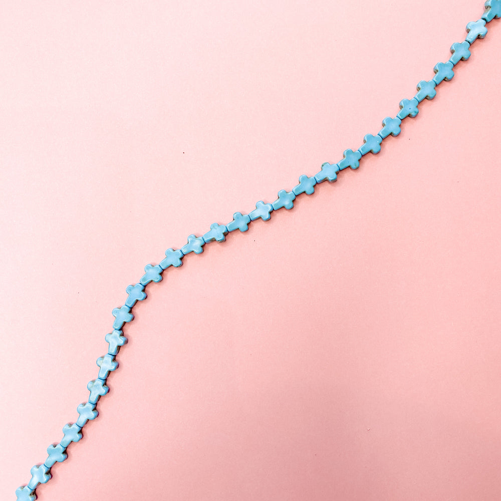 
                
                    Load image into Gallery viewer, 10mm Turquoise Dyed Magnesite Cross Strand - Christine White Style
                
            