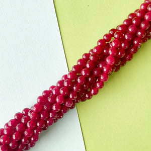 
                
                    Load image into Gallery viewer, 6mm Pomegranate Dyed Jade Faceted Round Strand
                
            
