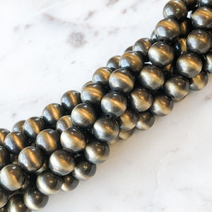 
                
                    Load image into Gallery viewer, 8mm Metallic Gold Navajo Rounds Strand - Christine White Style
                
            