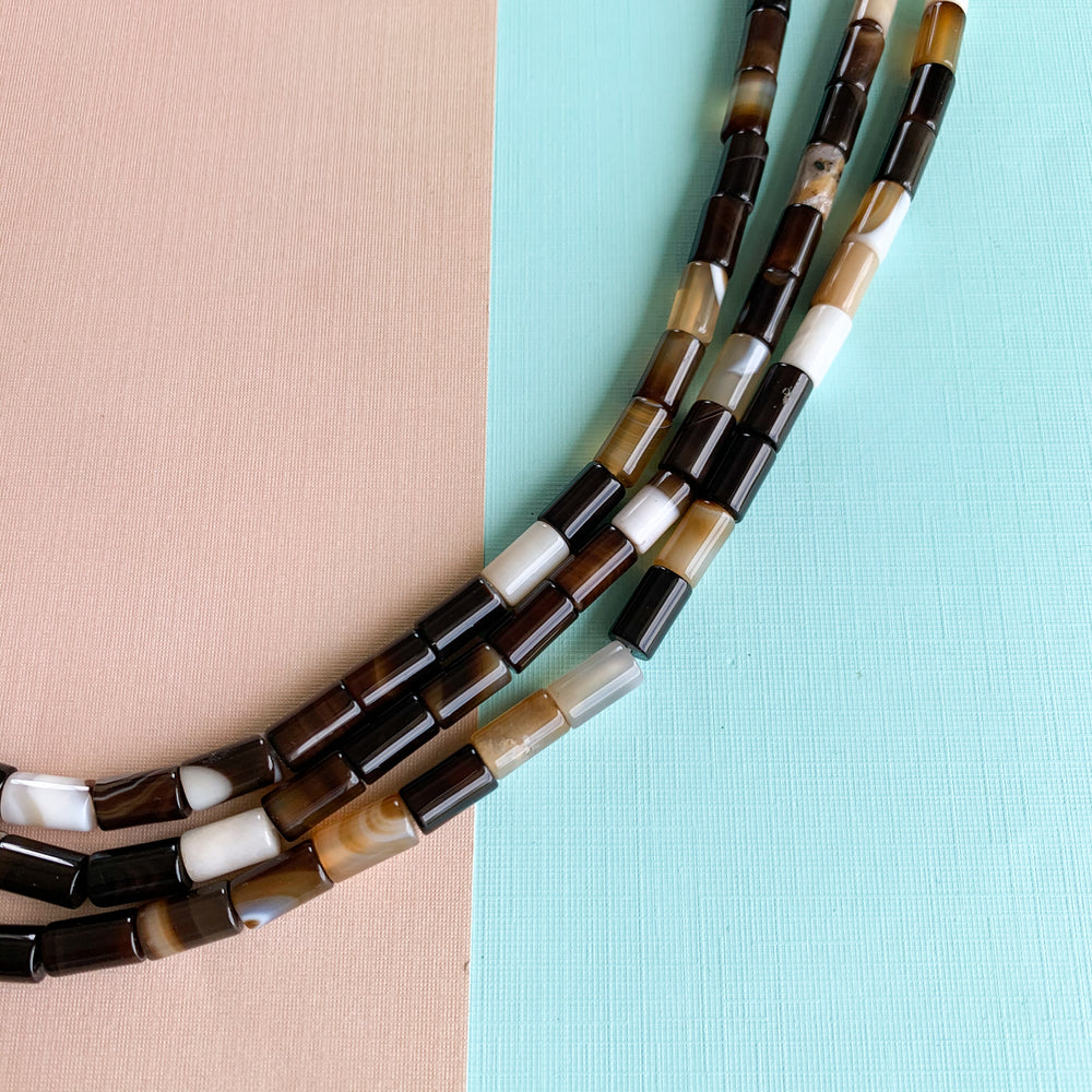 
                
                    Load image into Gallery viewer, 12mm Black Agate Barrel Strand
                
            