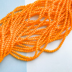 
                
                    Load image into Gallery viewer, 4mm Opaque Orange Faceted Chinese Crystal Rondelle Strand
                
            