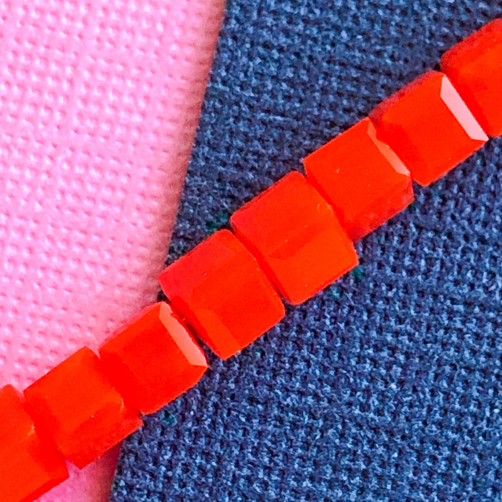 
                
                    Load image into Gallery viewer, 3mm Bright Orange Faceted Cube Crystal Strand
                
            