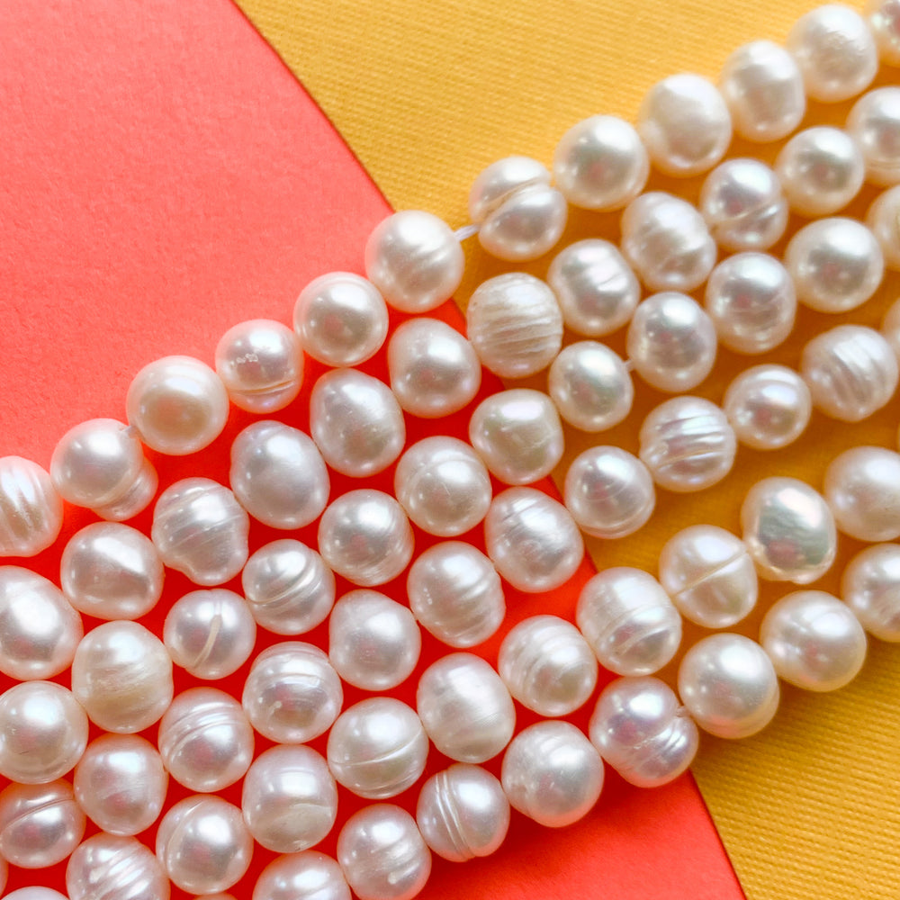 
                
                    Load image into Gallery viewer, 5-6mm White Freshwater Pearl Rounds Strand
                
            